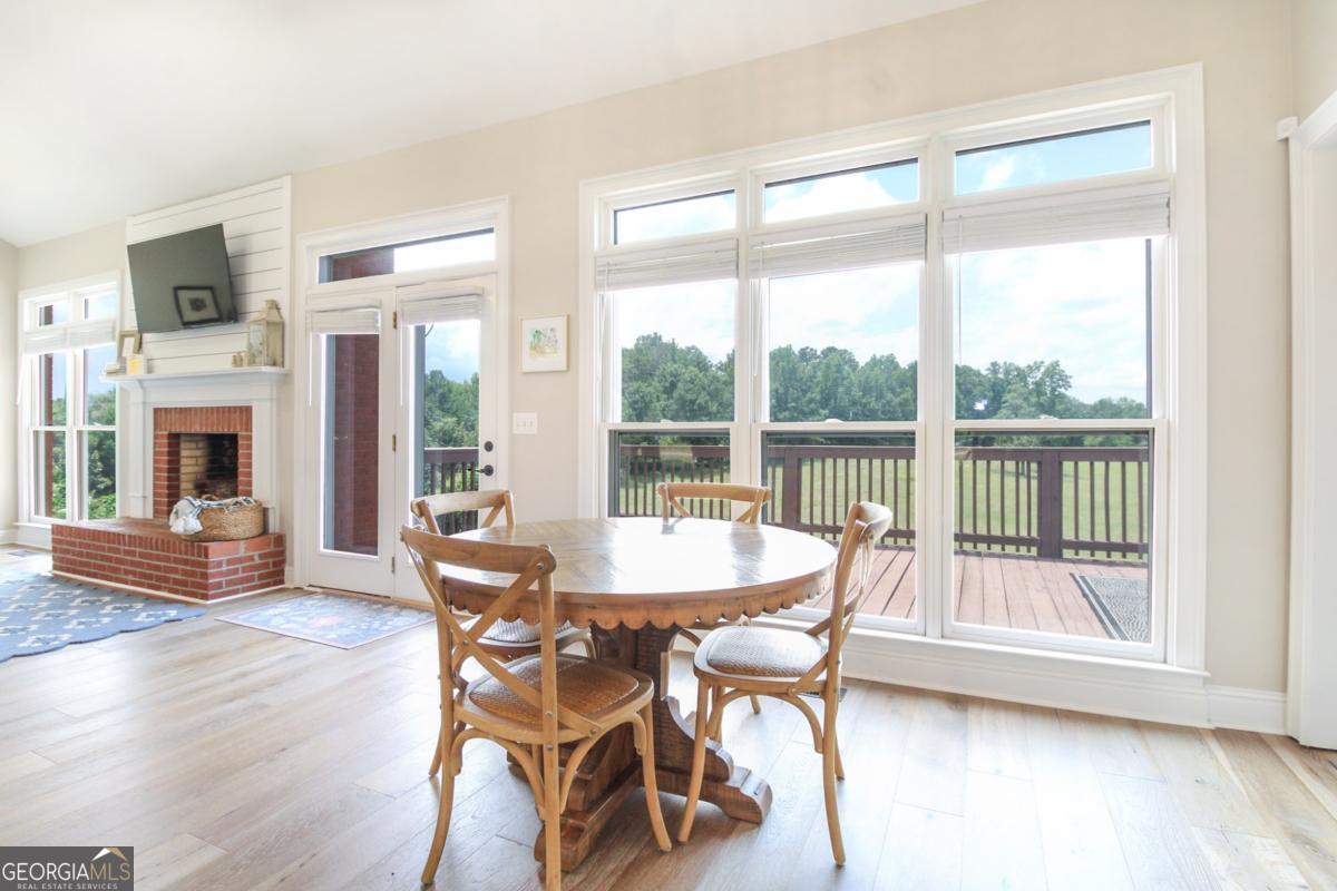 1380 Sunset Ridge Watkinsville, GA 30677 - Photo 14 of 74 a dining room with furniture water view and a fireplace