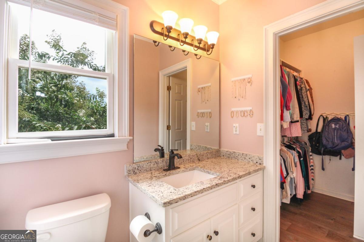 1380 Sunset Ridge Watkinsville, GA 30677 - Photo 19 of 74 a bathroom with a granite countertop sink and a mirror next to a window