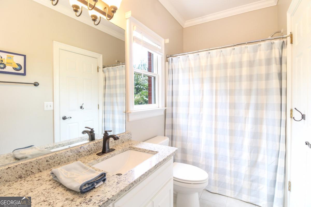 1380 Sunset Ridge Watkinsville, GA 30677 - Photo 24 of 74 a bathroom with a granite countertop sink and a mirror