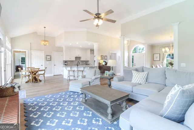 a living room with furniture a dining table and a piano