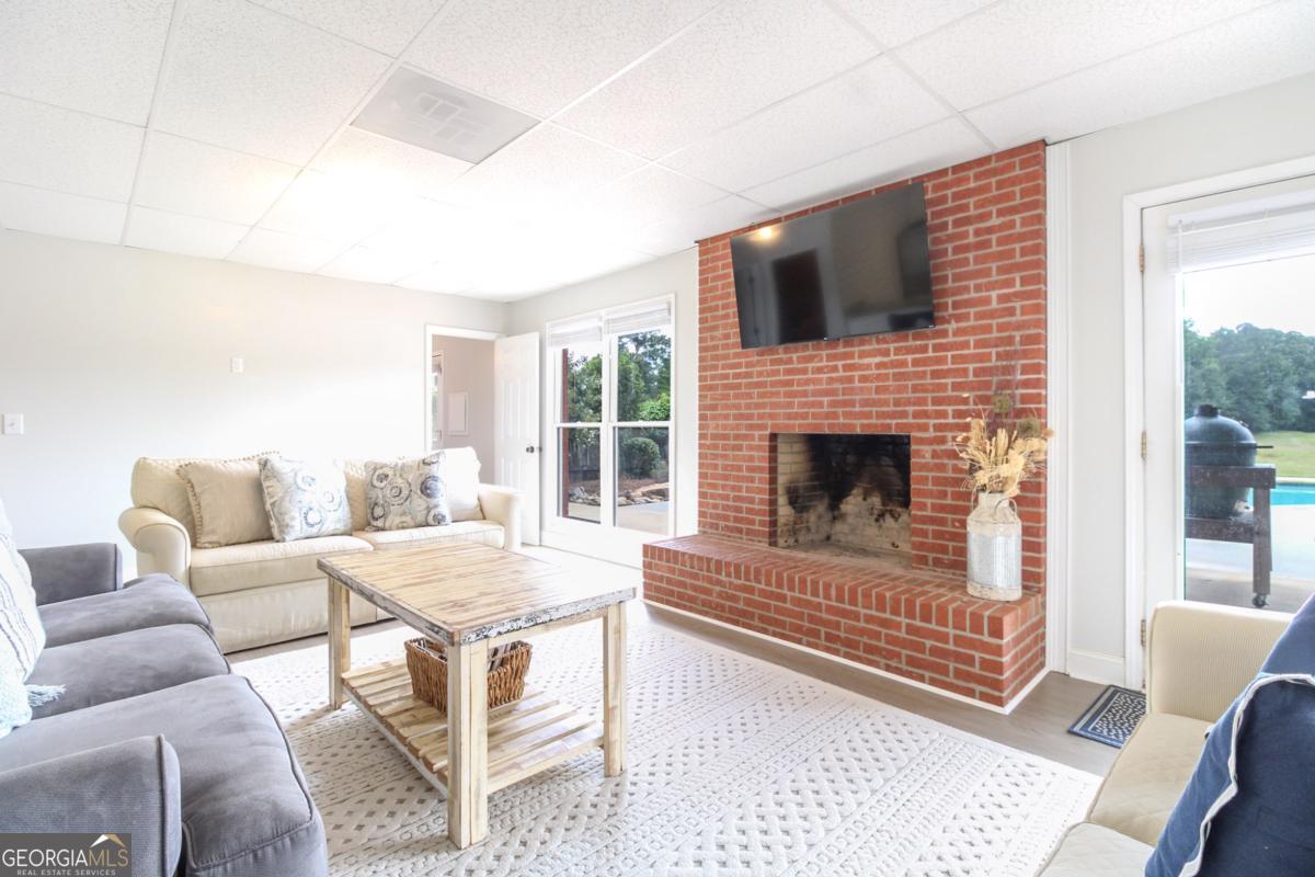 1380 Sunset Ridge Watkinsville, GA 30677 - Photo 32 of 74 a living room with furniture and a fireplace