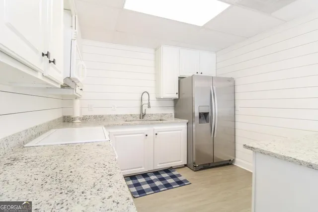 a view of a deck with wooden floor and floor to ceiling window