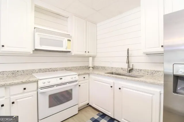 a view of a house with a yard and sitting area