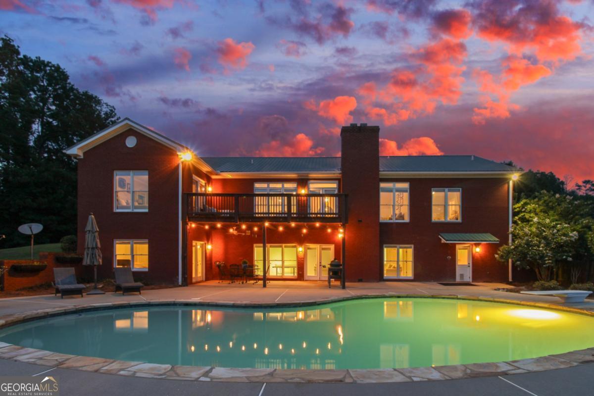 1380 Sunset Ridge Watkinsville, GA 30677 - Photo 46 of 74 a view of a building with a swimming pool