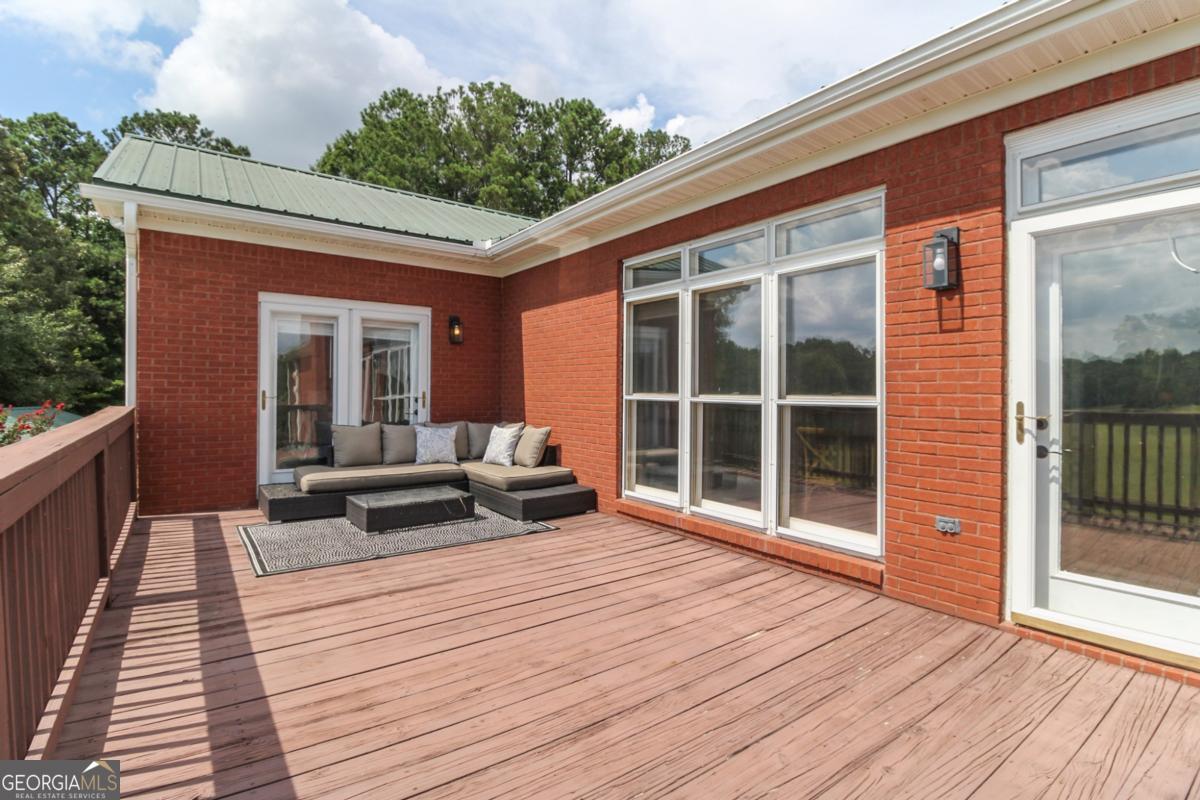 1380 Sunset Ridge Watkinsville, GA 30677 - Photo 47 of 74 a view of a deck with wooden floor and floor to ceiling window