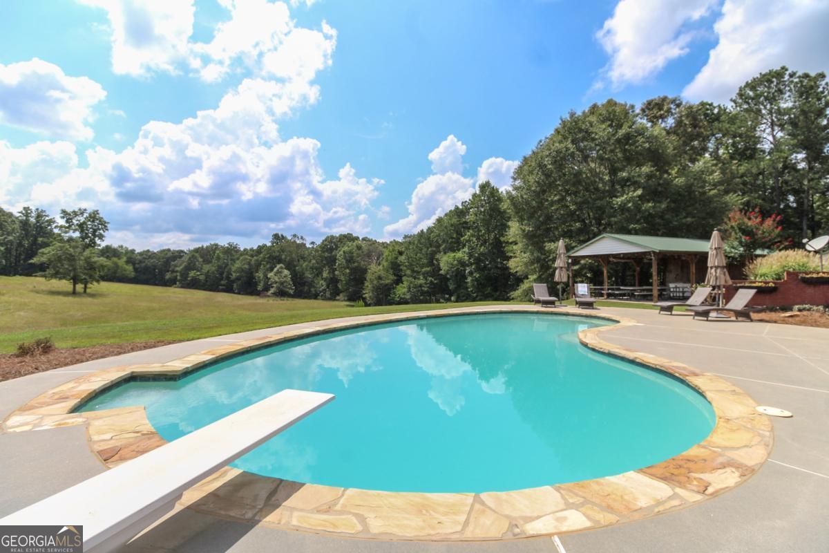 1380 Sunset Ridge Watkinsville, GA 30677 - Photo 49 of 74 a view of a swimming pool with a yard