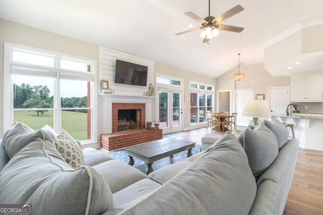 a living room with furniture fireplace and a flat screen tv