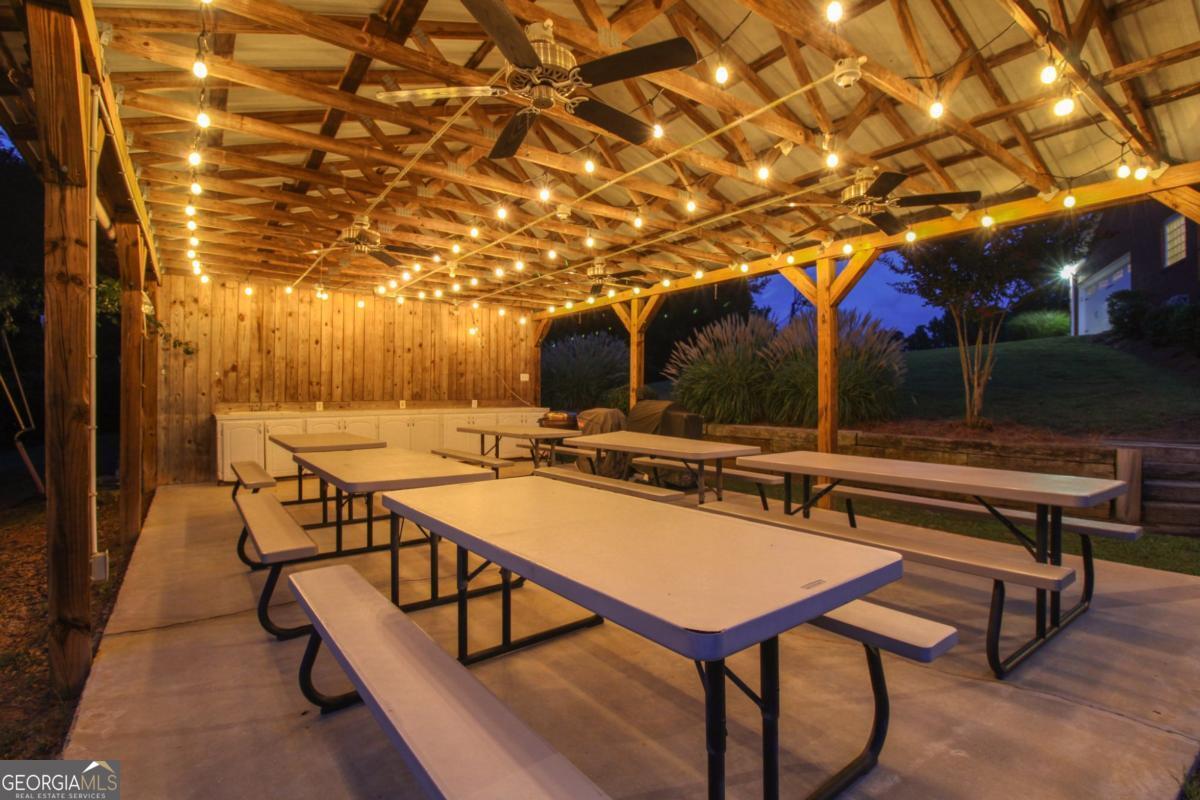 1380 Sunset Ridge Watkinsville, GA 30677 - Photo 52 of 74 a view of a patio with a table and chairs under an umbrella with a small yard