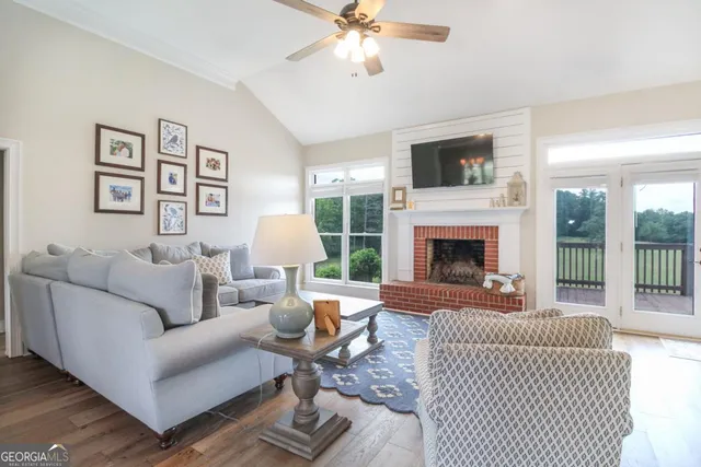a living room with furniture fireplace and flat screen tv