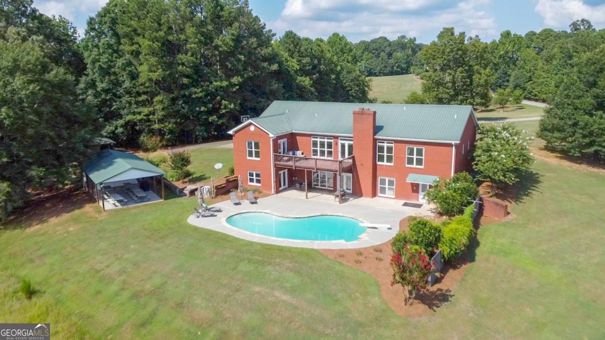 1380 Sunset Ridge Watkinsville, GA 30677 - Photo 64 of 74 an aerial view of a house with swimming pool and trees all around