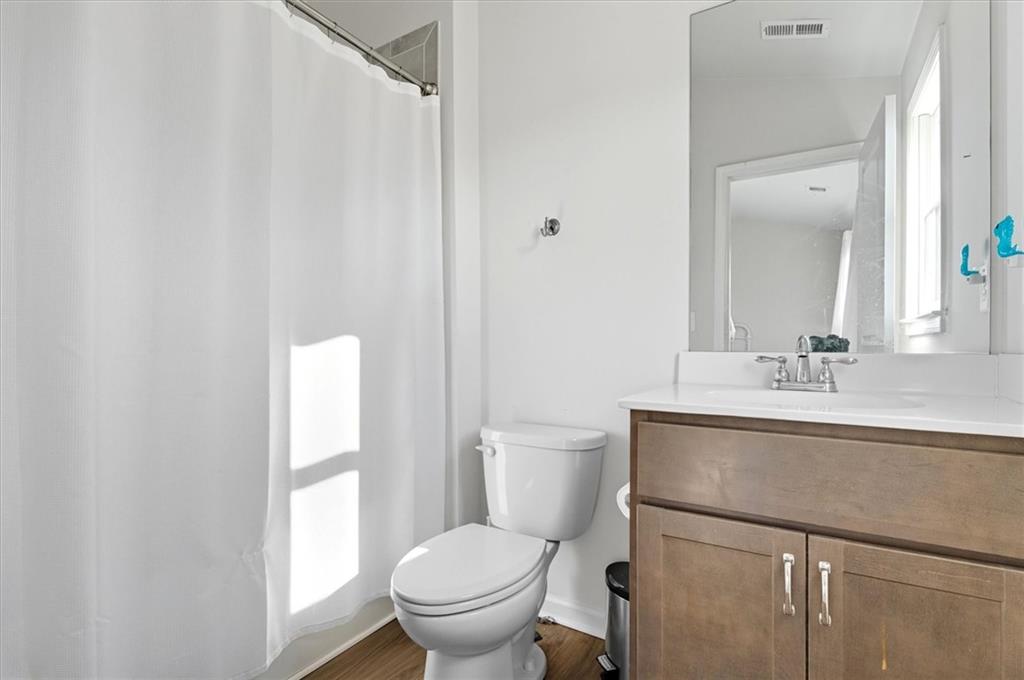 1157 Rambler Cross Atlanta, GA 30312 - Photo 26 of 49 a bathroom with a toilet a sink and a window