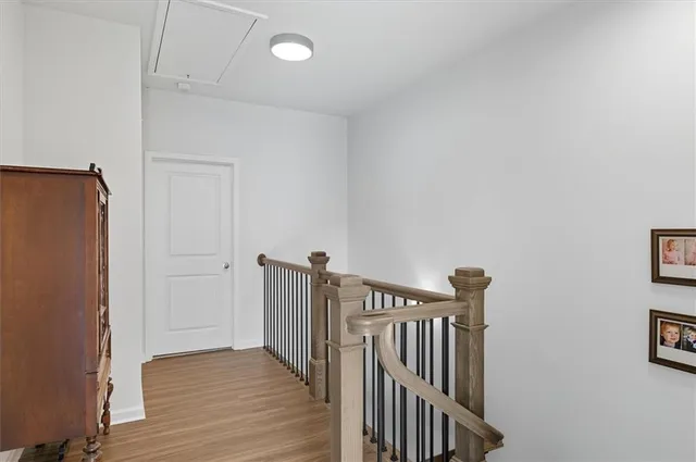 a view of hallway with wooden floor