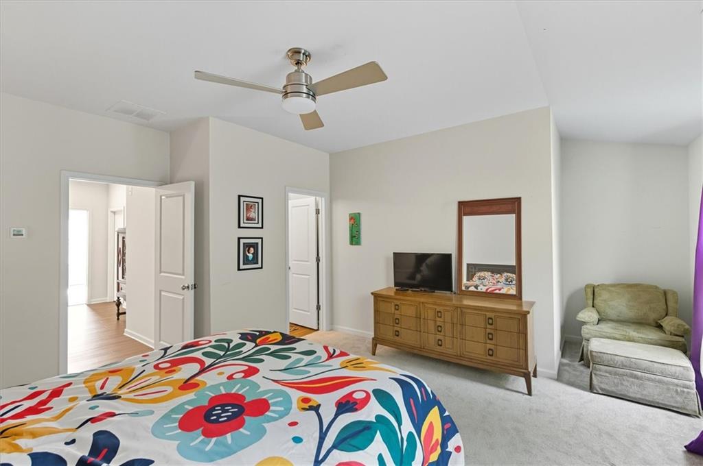 1157 Rambler Cross Atlanta, GA 30312 - Photo 34 of 49 a bedroom with a bed and a chandelier