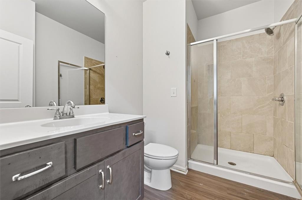 1157 Rambler Cross Atlanta, GA 30312 - Photo 41 of 49 a bathroom with a shower sink vanity mirror and toilet