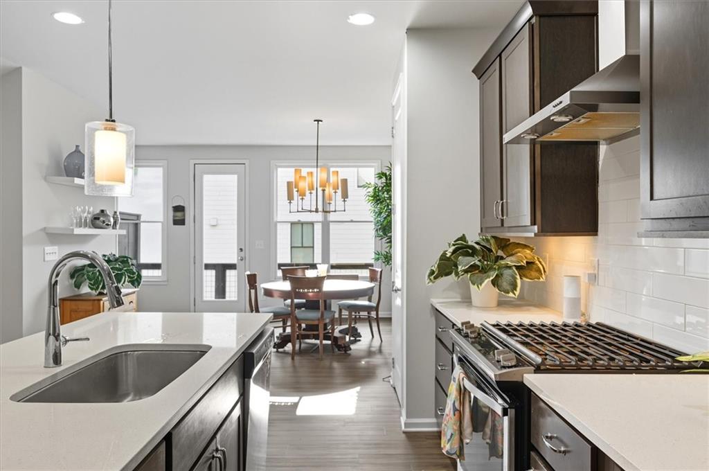 1157 Rambler Cross Atlanta, GA 30312 - Photo 10 of 49 a kitchen with granite countertop a sink a counter space appliances and cabinets