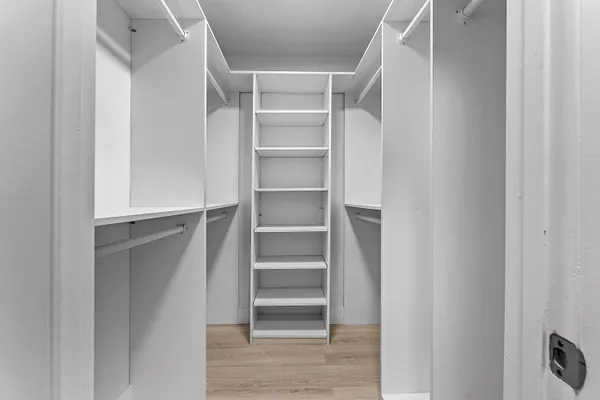 a view of walk in closet with empty racks