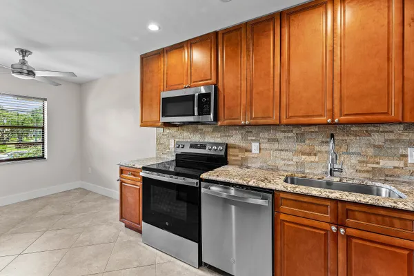 a kitchen with a stove microwave and sink