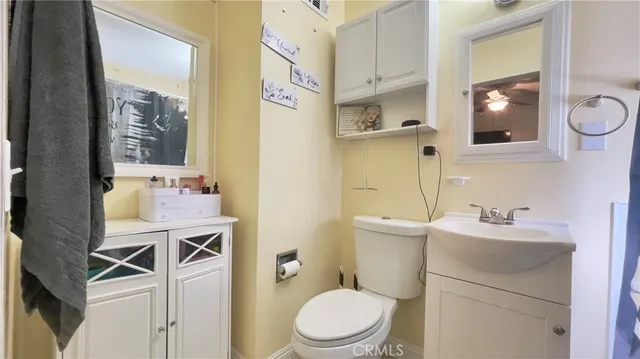 a bathroom with a sink mirror vanity and toilet