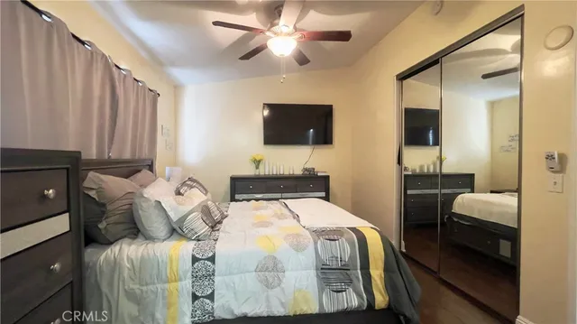 a bedroom with a bed and a flat screen tv