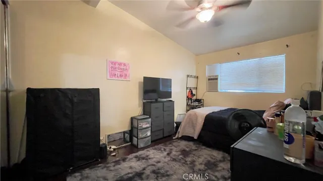 a bedroom with a bed and a television