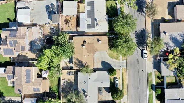 an aerial view of residential houses with outdoor space and parking