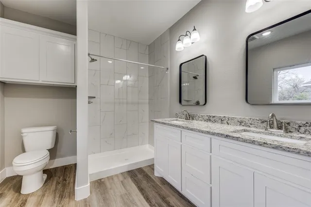 a bathroom with a toilet sink and shower