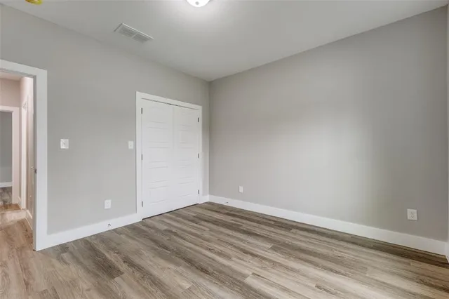 a view of room with wooden floor