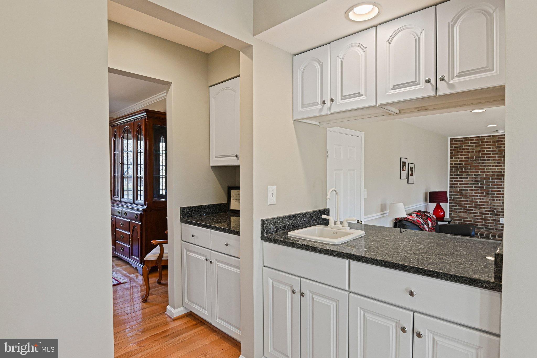 2707 Glencroft Road Vienna, VA 22181 - Photo 17 of 53 a kitchen with white cabinets and sink