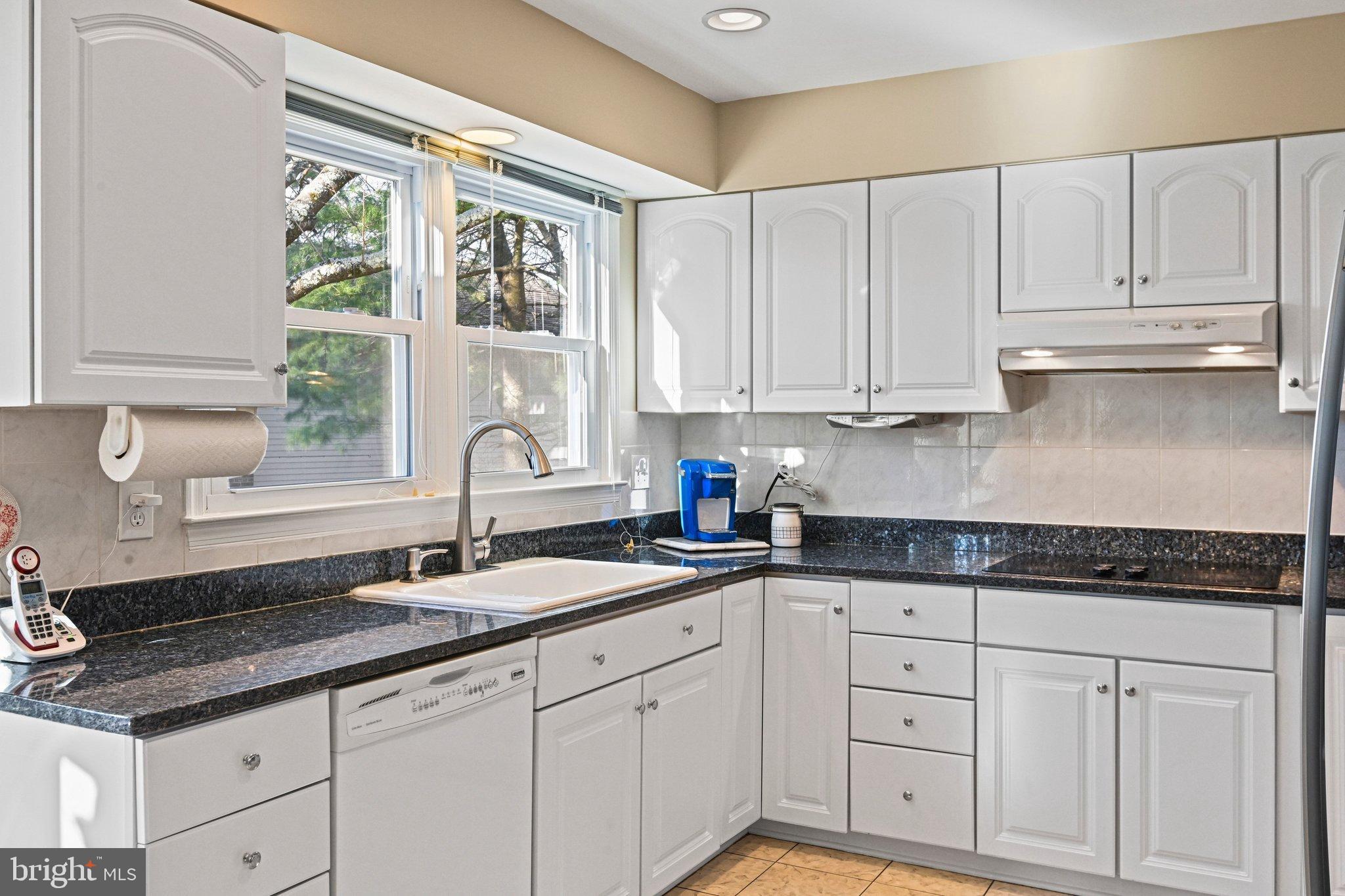 2707 Glencroft Road Vienna, VA 22181 - Photo 21 of 53 a kitchen with granite countertop white cabinets and a window