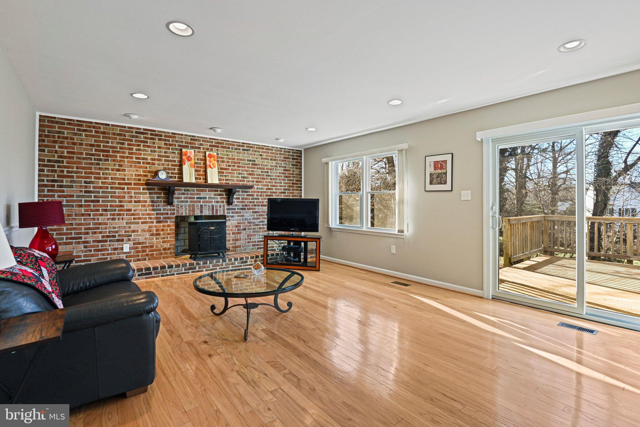 2707 Glencroft Road Vienna, VA 22181 - Photo 25 of 53 a living room with furniture a flat screen tv and a fireplace