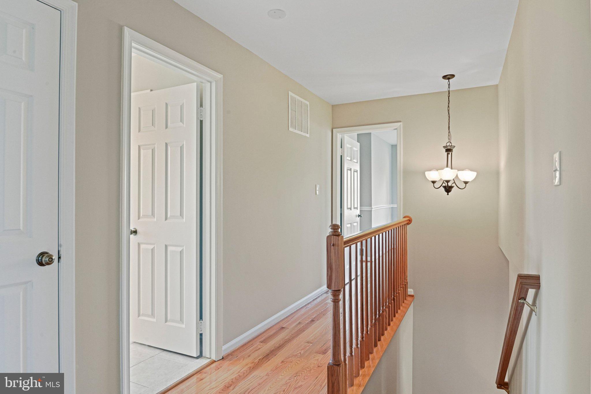 2707 Glencroft Road Vienna, VA 22181 - Photo 27 of 53 a view of a hallway with wooden floor and staircase