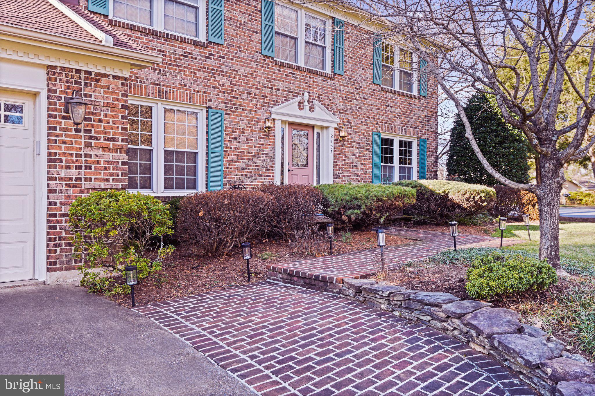 2707 Glencroft Road Vienna, VA 22181 - Photo 3 of 53 a view of a brick house with many windows plants and large trees