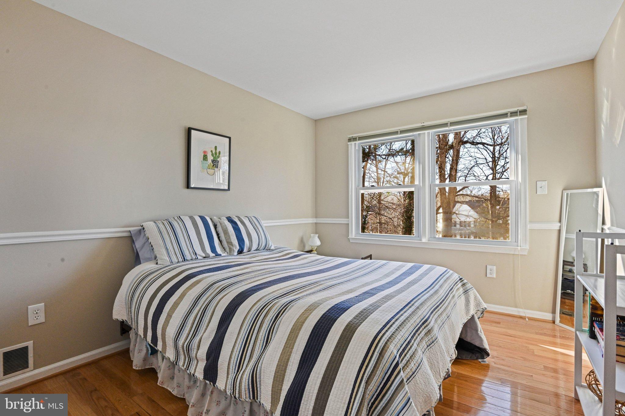 2707 Glencroft Road Vienna, VA 22181 - Photo 34 of 53 a bed sitting in a bedroom next to a window
