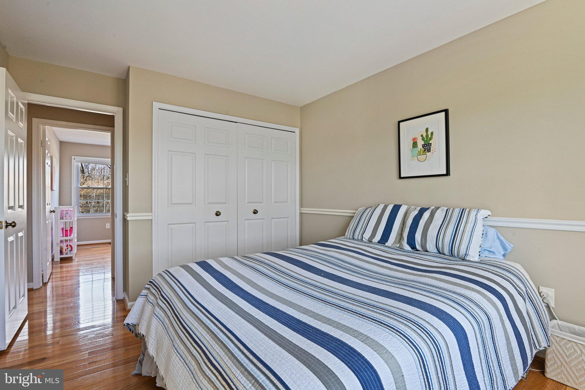 2707 Glencroft Road Vienna, VA 22181 - Photo 35 of 53 a bedroom with a bed and wooden floor