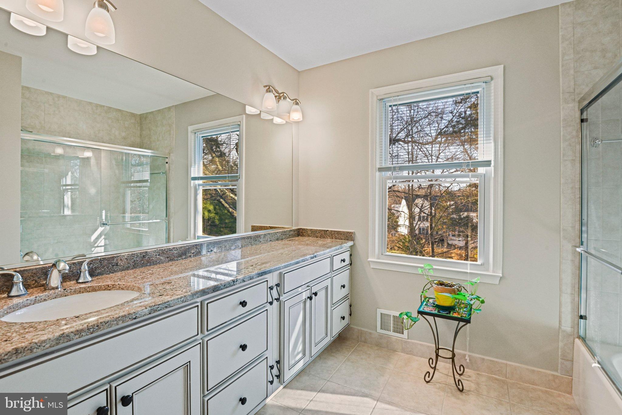 2707 Glencroft Road Vienna, VA 22181 - Photo 40 of 53 a spacious bathroom with a granite countertop sink and a window