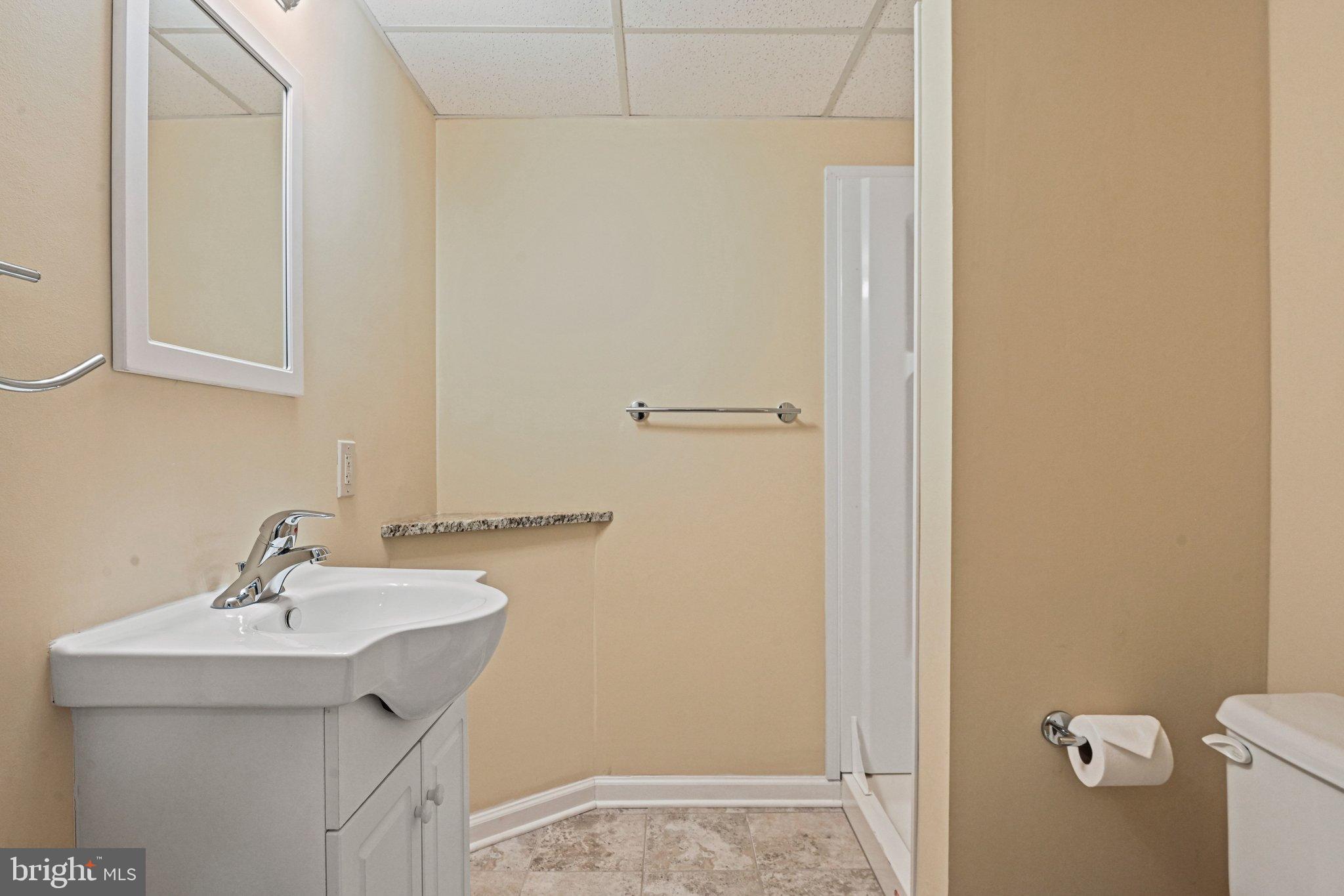 2707 Glencroft Road Vienna, VA 22181 - Photo 47 of 53 a bathroom with a sink and mirror
