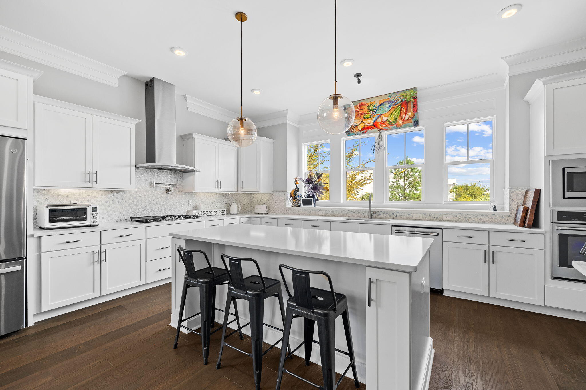 4 Clipper Street Inlet Beach, FL 32461 - Photo 18 of 49 a kitchen with stainless steel appliances granite countertop a stove a sink and white cabinets with wooden floor