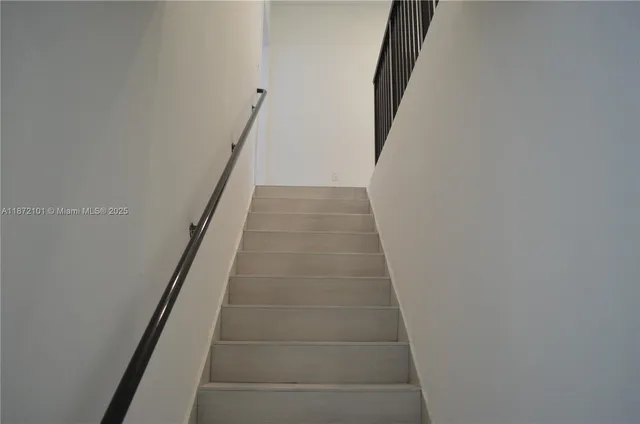 a view of a staircase with wooden floor