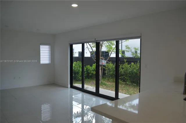 a view of an empty room with windows