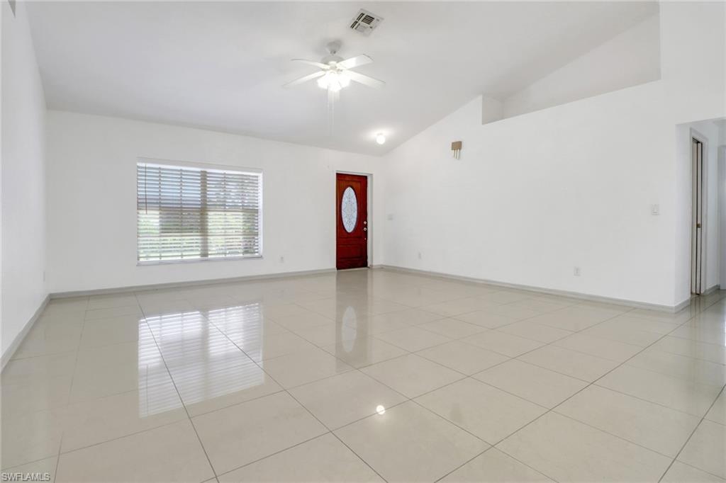 765 Aprile Avenue South Lehigh Acres, FL 33974 - Photo 11 of 32 wooden floor in an empty room with a window