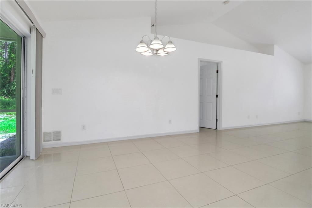 765 Aprile Avenue South Lehigh Acres, FL 33974 - Photo 13 of 32 a view of an empty room with a chandelier fan