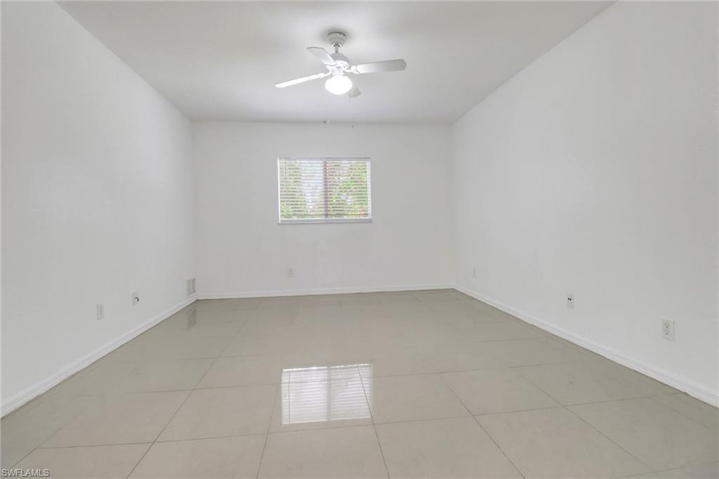 765 Aprile Avenue South Lehigh Acres, FL 33974 - Photo 15 of 32 an empty room with a window and a ceiling fan