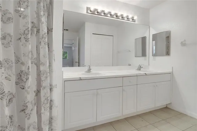 a bathroom with a double vanity sink and a mirror