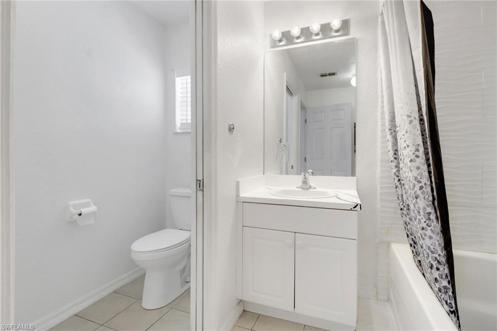 765 Aprile Avenue South Lehigh Acres, FL 33974 - Photo 20 of 32 a bathroom with a sink a toilet and shower