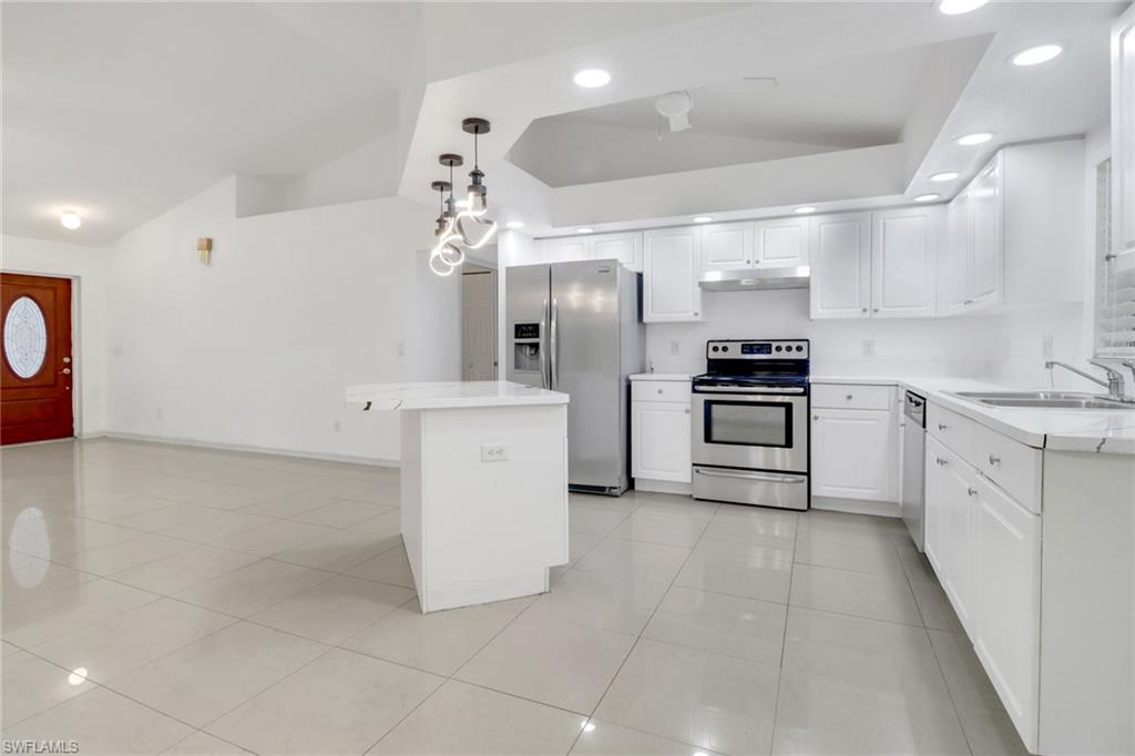 765 Aprile Avenue South Lehigh Acres, FL 33974 - Photo 5 of 32 a kitchen with a sink and white cabinets