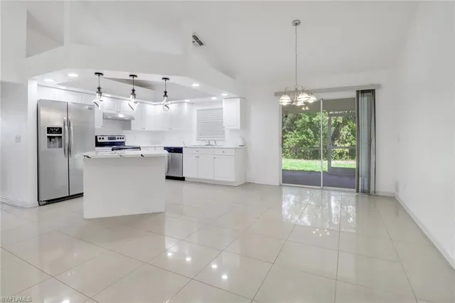 a large kitchen with a lot of counter space and appliances