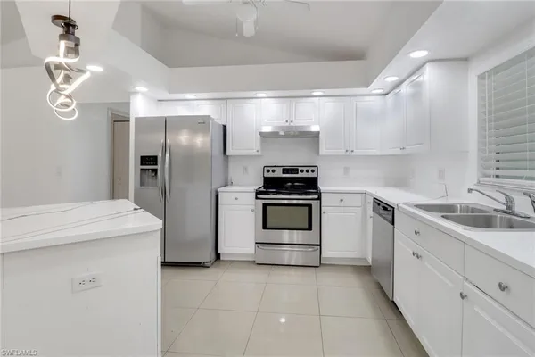 a kitchen with a sink stainless steel appliances and cabinets