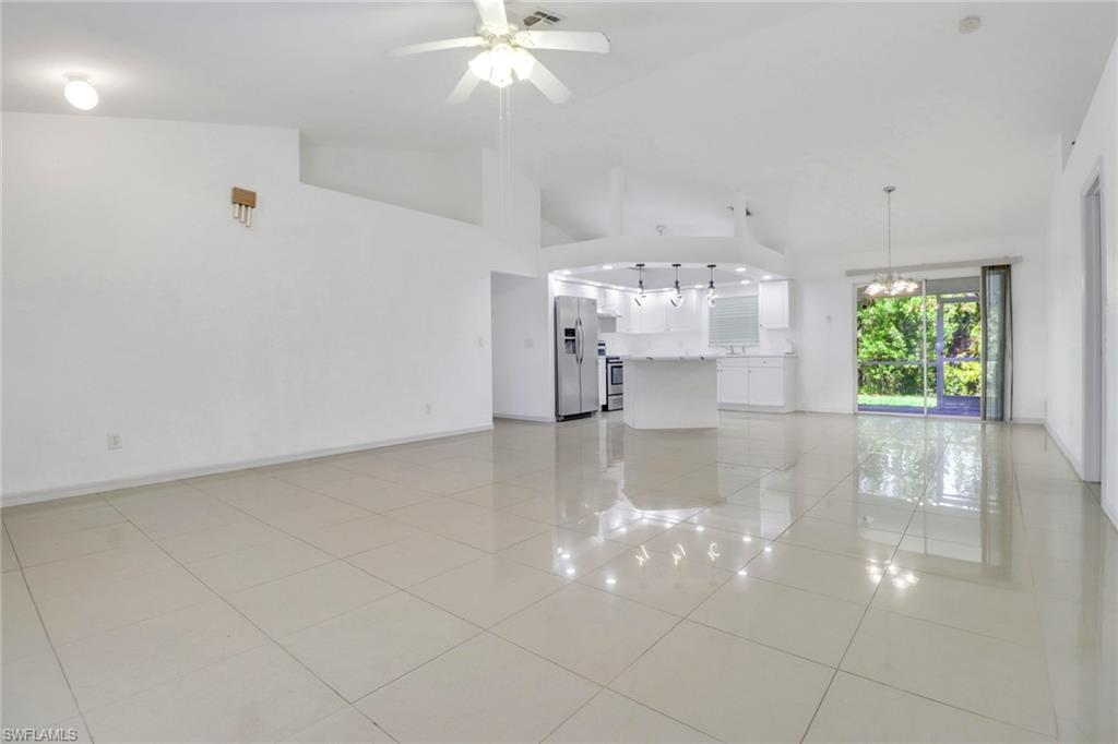 765 Aprile Avenue South Lehigh Acres, FL 33974 - Photo 10 of 32 a view of a room with a chandelier