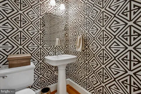 a spacious bathroom with a granite countertop sink and a mirror