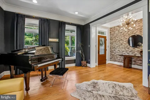 a living room with furniture and floor to ceiling windows